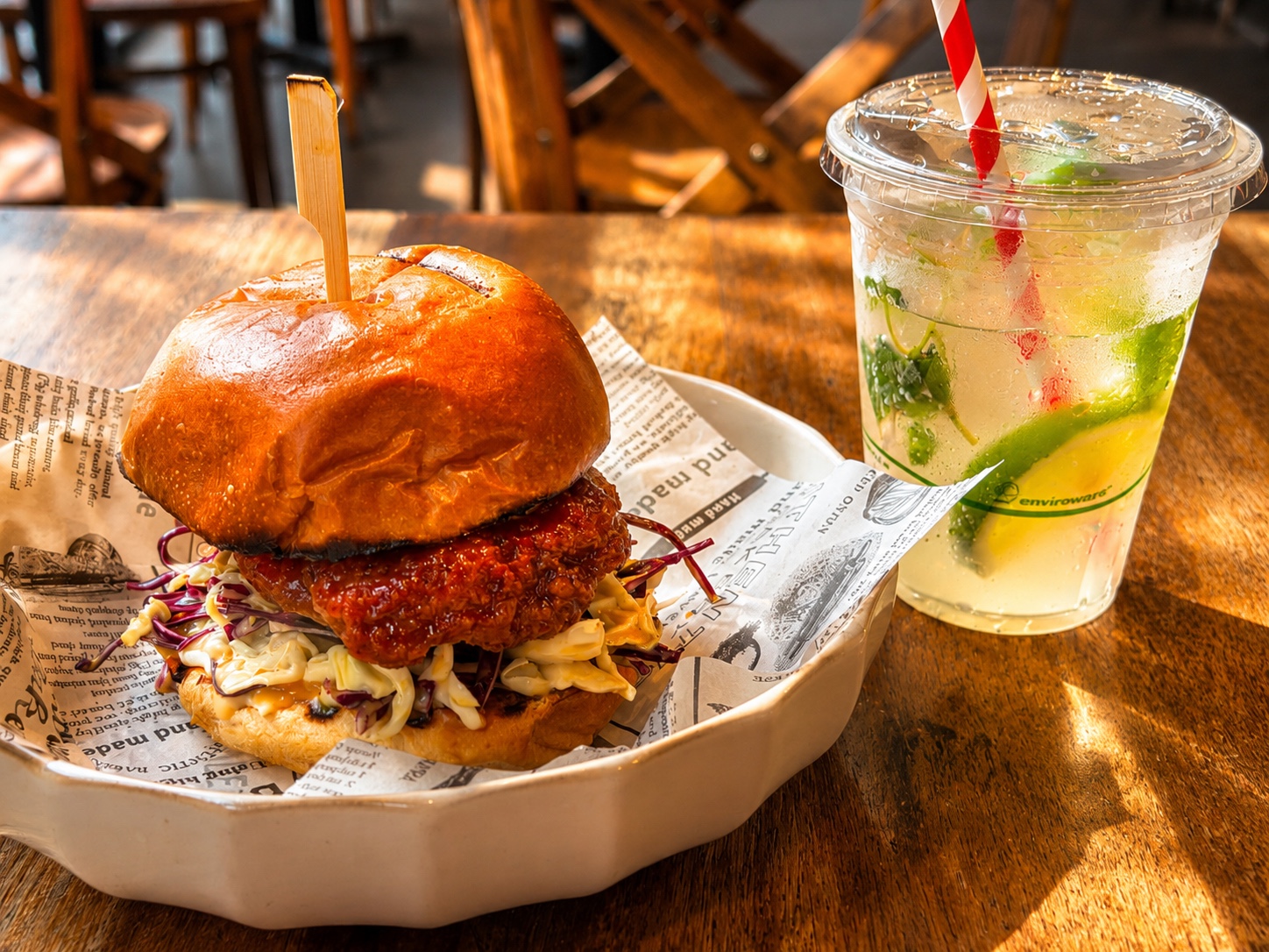 Crispy chicken burger with a citrus drink